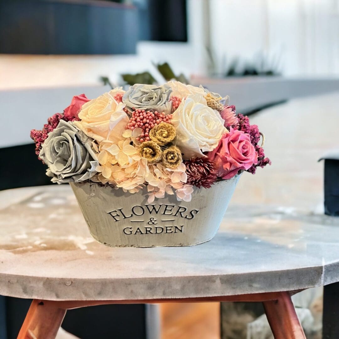 A table with flowers in it on top of a white table.