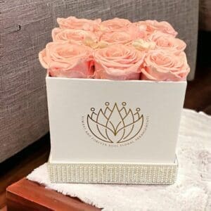 A white box with pink roses in it