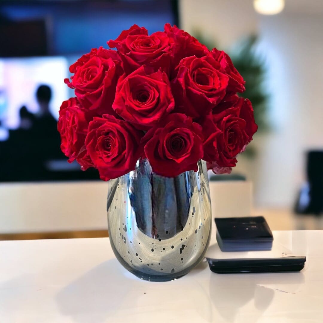 A vase of red roses on the table