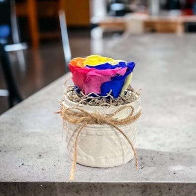 A candle in a jar on top of a table.