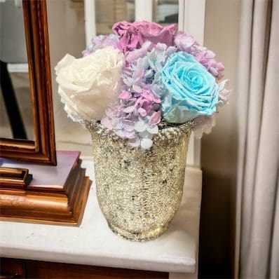 A vase with flowers on top of a table.