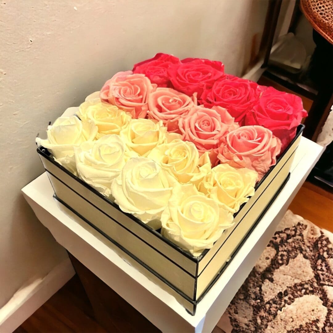 A box of roses on top of a table.