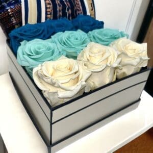 A box of flowers on top of a table.