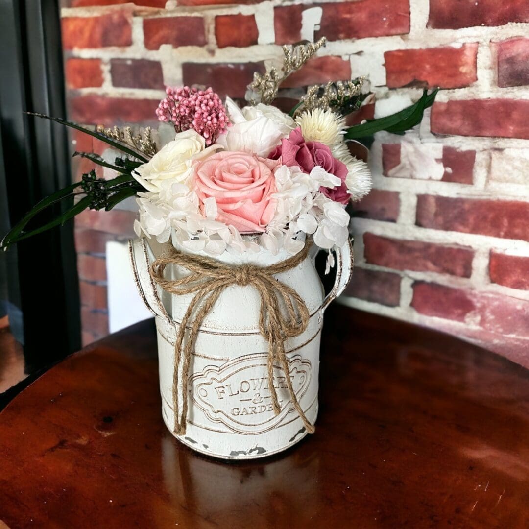 A vase with flowers on top of a table.