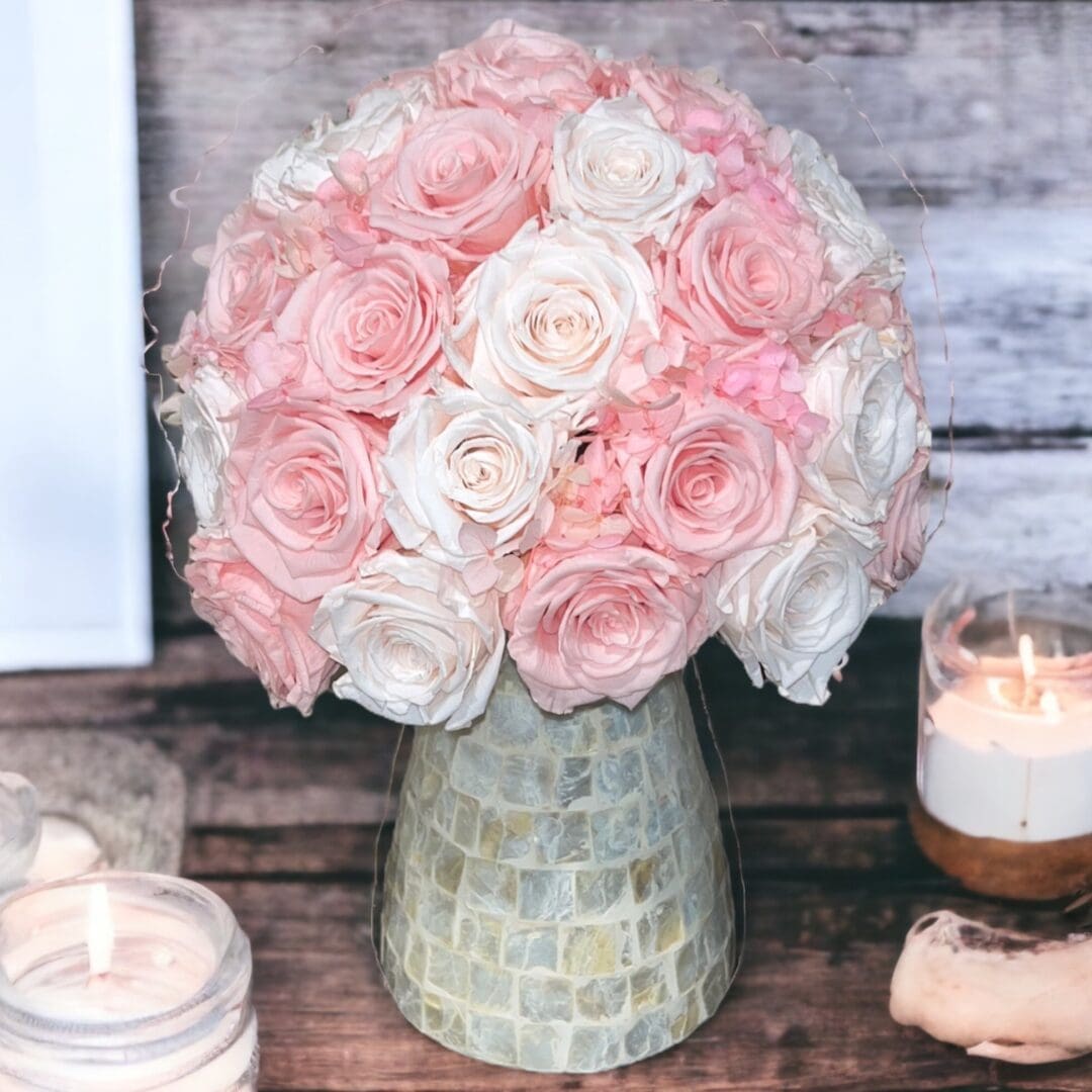 A vase filled with pink and white flowers.
