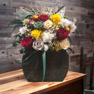 A wooden table with flowers in it