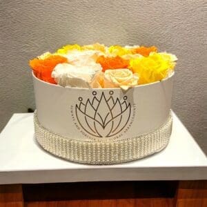 A white cake with flowers in it on top of a table.