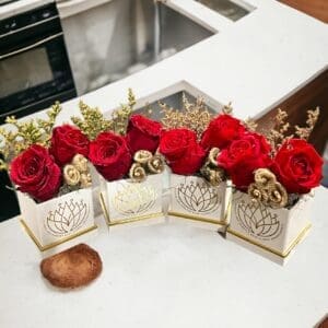 A table with four boxes of flowers on it