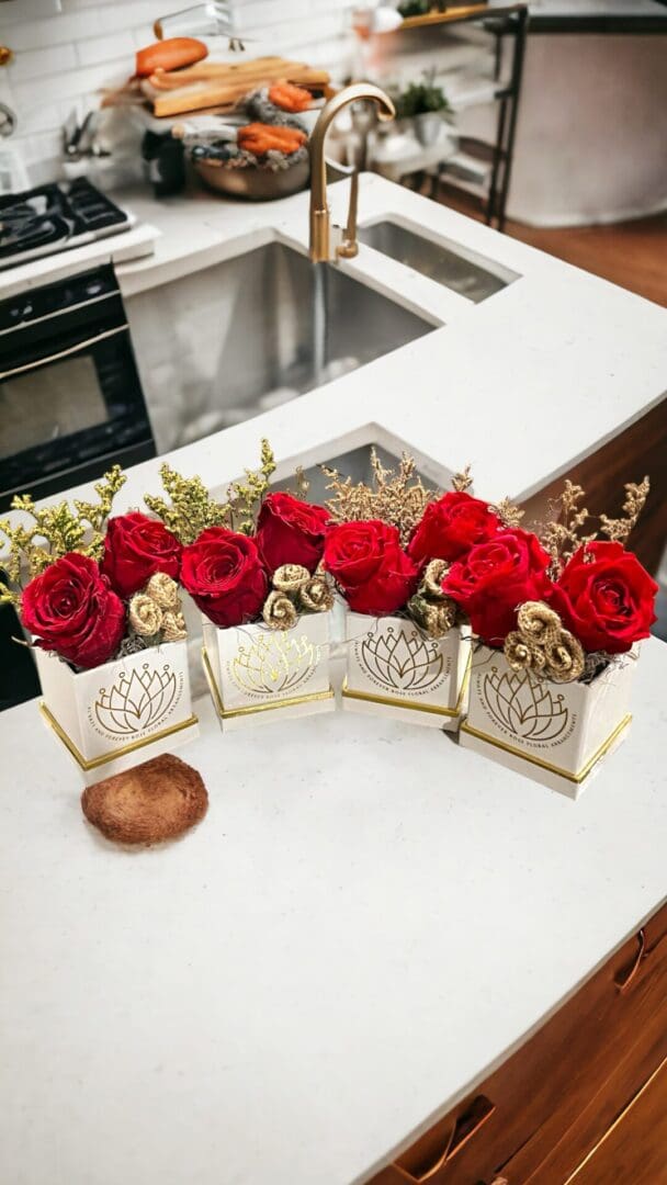 A table with four boxes of flowers on it